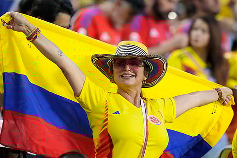 Colombia fan cheers as she waits for the start of final match